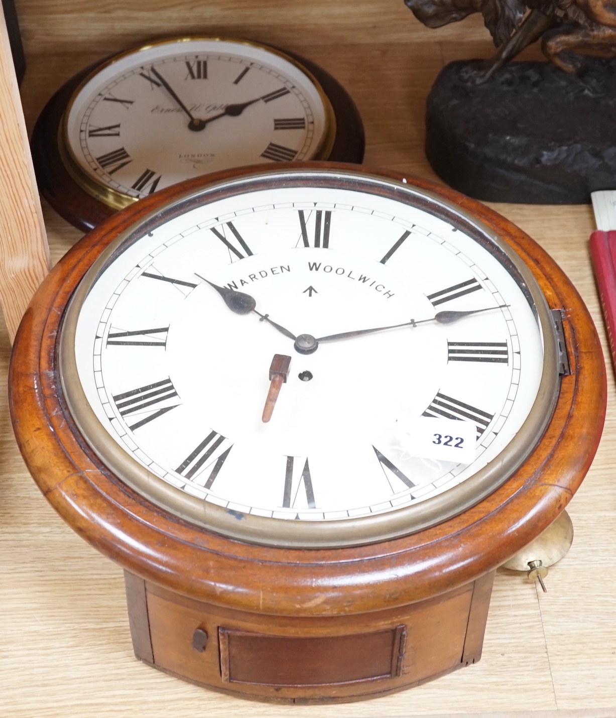 An Edwardian mahogany single fusee wall timepiece, The dial signed Warden Woolwich, the movement stamped Warren 1903/52 and later clock by Ernest N. Gibbs, London (2), largest 46cm diameter